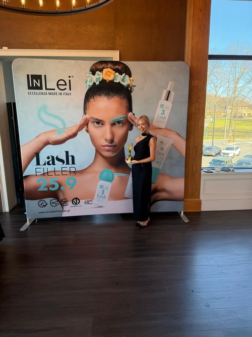 Swan Thang beside an InLei lash filler display