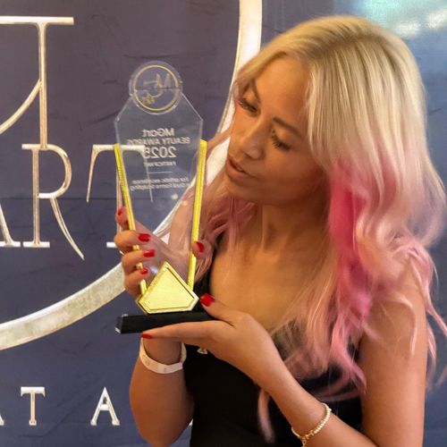 Swan Thang holding an industry award