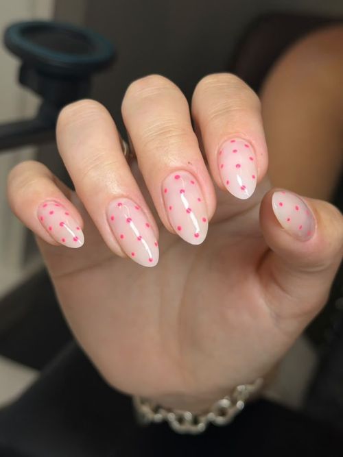 Pink dot nail art on long almond nails